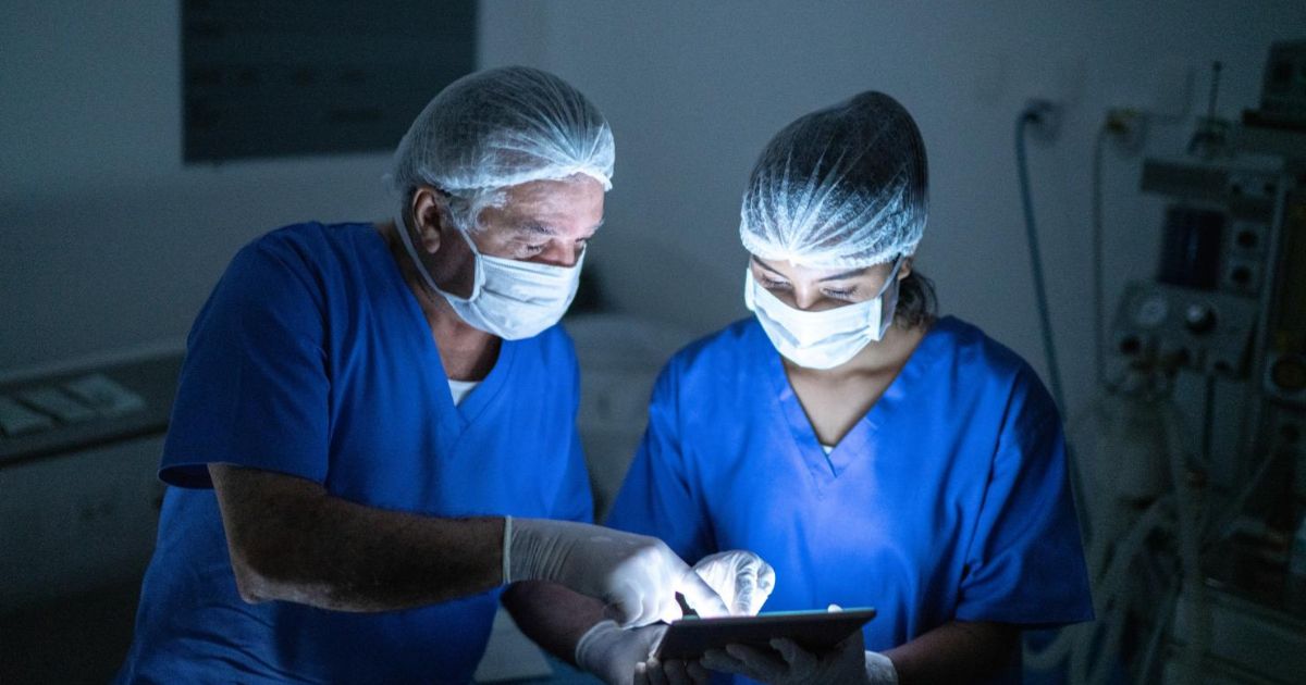Doctors in surgery looking at a tablet